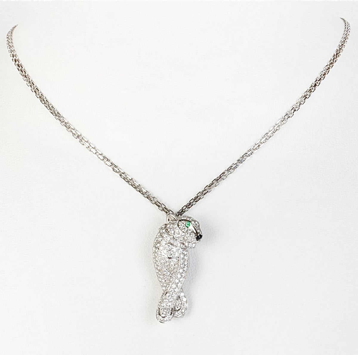Silver-tone bird pendant necklace with clear pavé-style stones and green eye accent
