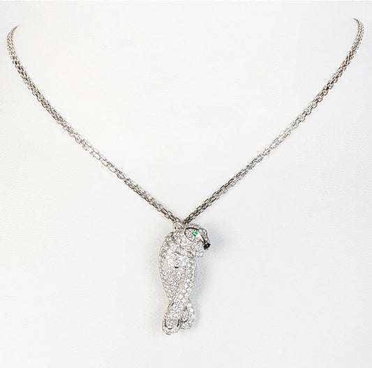 Silver-tone bird pendant necklace with clear pavé-style stones and green eye accent
